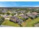 Aerial view of a two-story house with a pool and a large backyard, near a pond at 116 Caladium Ct, Bradenton, FL 34212