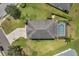 Top-down view of a house with a dark roof, pool, and paved driveway at 116 Caladium Ct, Bradenton, FL 34212