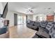 Gathering room with leather sectional, ceiling fan, and view into kitchen at 116 Caladium Ct, Bradenton, FL 34212