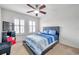 Bedroom with ceiling fan, blue bedding, and plantation shutters at 116 Caladium Ct, Bradenton, FL 34212