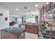Open kitchen boasts dark wood cabinets, granite countertops, and stainless steel appliances at 116 Caladium Ct, Bradenton, FL 34212