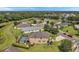 Aerial view of a house with a pool and a large backyard in a quiet neighborhood at 116 Caladium Ct, Bradenton, FL 34212