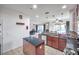 Open concept kitchen with island, stainless steel appliances, and granite countertops at 116 Caladium Ct, Bradenton, FL 34212