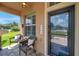Front porch with wicker chairs and a glass door at 116 Caladium Ct, Bradenton, FL 34212