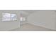 Bright bedroom with window and neutral carpeting at 4654 Mirabella Ct, St Pete Beach, FL 33706
