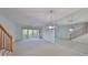 Bright living room with mirrored wall and access to balcony at 4654 Mirabella Ct, St Pete Beach, FL 33706