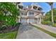 Two story townhome with attached garage and lush landscaping at 4654 Mirabella Ct, St Pete Beach, FL 33706