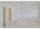 Bright bedroom with ceiling fan and access to bathroom at 4654 Mirabella Ct, St Pete Beach, FL 33706