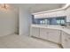 Kitchen boasts white cabinets and overlooks the living room at 4654 Mirabella Ct, St Pete Beach, FL 33706