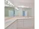 Bathroom with double vanity and large mirror at 4654 Mirabella Ct, St Pete Beach, FL 33706