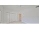 Simple bedroom with ceiling fan and double doors to closet at 4654 Mirabella Ct, St Pete Beach, FL 33706