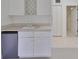 Basement wet bar with sink, mini-fridge, and wine rack at 4654 Mirabella Ct, St Pete Beach, FL 33706