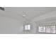 Bedroom with ceiling fan and window at 4654 Mirabella Ct, St Pete Beach, FL 33706