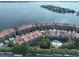 Aerial view of community with waterfront access and pool at 4654 Mirabella Ct, St Pete Beach, FL 33706