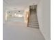 Living area with kitchen bar, carpeted floors and stairs at 4654 Mirabella Ct, St Pete Beach, FL 33706