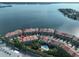 Aerial view of waterfront community with multiple buildings, pool, and boat slips at 4654 Mirabella Ct, St Pete Beach, FL 33706