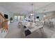 Open concept dining area with adjacent living room and kitchen at 4654 Mirabella Ct, St Pete Beach, FL 33706