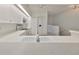 White kitchen with a breakfast bar and stainless steel appliances at 4654 Mirabella Ct, St Pete Beach, FL 33706