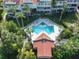 Community pool with surrounding patio and lounge chairs at 4654 Mirabella Ct, St Pete Beach, FL 33706