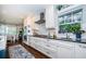 White shaker cabinets, granite countertops, and stainless steel appliances highlight this kitchen at 311 Sunset N Dr, St Petersburg, FL 33710