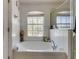 Bathroom with garden tub and large window at 8556 Southern Charm Cir, Brooksville, FL 34613