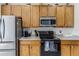 Kitchen features stainless steel appliances and wood cabinets at 8556 Southern Charm Cir, Brooksville, FL 34613