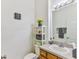 Clean bathroom with vanity, toilet, and shelving unit at 8556 Southern Charm Cir, Brooksville, FL 34613
