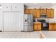 Kitchen with stainless steel refrigerator and wood cabinets at 8556 Southern Charm Cir, Brooksville, FL 34613