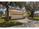 Two-car garage with driveway and landscaping at 8556 Southern Charm Cir, Brooksville, FL 34613