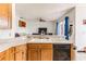 Kitchen with double sink, dishwasher, and view to living room at 8556 Southern Charm Cir, Brooksville, FL 34613