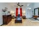 Living room with hardwood floors, comfortable seating, and ceiling fan at 8556 Southern Charm Cir, Brooksville, FL 34613