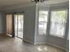 Dining area with tile floor, sliding doors to patio, and bay window at 62 Emerald Bay Dr, Oldsmar, FL 34677