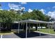 Exterior view of unit with carport and landscaping at 62 Emerald Bay Dr, Oldsmar, FL 34677