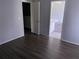 Bedroom with laminate wood floor and access to bathroom at 62 Emerald Bay Dr, Oldsmar, FL 34677