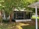 Exterior view of screened porch and landscaping at 62 Emerald Bay Dr, Oldsmar, FL 34677