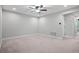 Spacious bedroom with ceiling fan and neutral wall color at 2505 Arch Ave, Oldsmar, FL 34677
