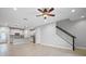 Open living room with wood-look tile floors and a staircase at 2505 Arch Ave, Oldsmar, FL 34677