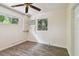 Bright bedroom with wood-look floors, window, and ceiling fan at 1618 Valencia St, Clearwater, FL 33756