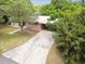 Pink house with carport and mature landscaping at 1618 Valencia St, Clearwater, FL 33756