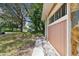 Sidewalk leading to the garage with mature trees at 1618 Valencia St, Clearwater, FL 33756