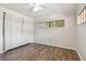 Bedroom featuring wood-look floors and a window with blinds at 1618 Valencia St, Clearwater, FL 33756