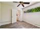 Bedroom with wood-look floors, window, and access to laundry at 1618 Valencia St, Clearwater, FL 33756