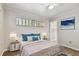 Bedroom with wood-look flooring, large window, and ceiling fan at 1618 Valencia St, Clearwater, FL 33756