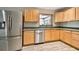 Kitchen with stainless steel appliances and wood cabinets at 1618 Valencia St, Clearwater, FL 33756