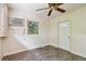 Bright bedroom with wood-look floors, window, and ceiling fan at 1618 Valencia St, Clearwater, FL 33756