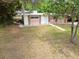 Mid-century ranch home with a pink facade and mature landscaping at 1618 Valencia St, Clearwater, FL 33756