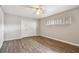 Bedroom with window, closet, and wood-look floors at 1618 Valencia St, Clearwater, FL 33756