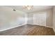 Bedroom with double door closet and wood-look floors at 1618 Valencia St, Clearwater, FL 33756