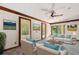 Living room features a ceiling fan and access to the patio at 1618 Valencia St, Clearwater, FL 33756