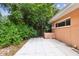 Side yard with concrete patio and landscaping at 1618 Valencia St, Clearwater, FL 33756